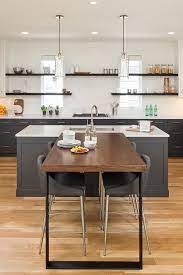 Usually the newest kitchen designs are made with breakfast bar, but everything depend on your needs and desirable kind of kitchen. This T Shaped Breakfast Bar Showcases A Wood Top Table With Black Iron Legs That Connects To A Kitchen Bar Table Kitchen Island Design T Shaped Kitchen Island
