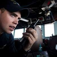 Operations Specialist 3rd Class Kenneth Jones plots a course aboard the  guided-missile cruiser USS Gettysburg (CG 64).