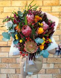 Native Bouquet With Proteas Snapdragons Roses Leucadendrons Billy Buttons And Hypericum Berr Flower Arrangements Flowers Bouquet Flower Arrangement Designs