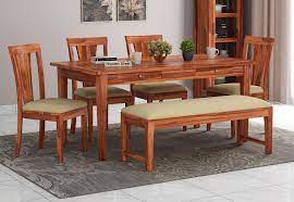 A dining table with bench is perfecy for havingdinner with your small kids. Buy Mcbeth Storage 6 Seater Dining Table Set With Bench Honey Finish Online In India Wooden Street