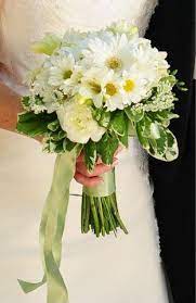 This adorable hand tied spring time bouquet is made up of silk gerbera daisies that are white with yellow centers and yellow ranunculuss. Pin By Michelle Imbach Walters On Wedding Flowers Flower Bouquet Wedding Daisy Bridal Bouquet Daisy Bouquet
