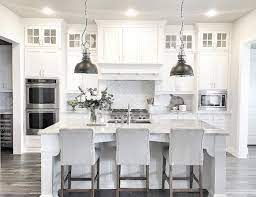 Raised Ranch Kitchen On Pinterest Ranch Kitchen Remodel Raised Kitchen Cabinets Decor White Kitchen Design Farmhouse Style Kitchen #light grey ( looks white really)stunning transitional kitchen features a stainless steel range sat against white herringbone backsplash tiles holding a light gray paneled hood flanked by light gray shaker.