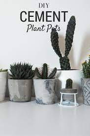 This concrete flower pot diy requires you to mix the concrete in a bucket with a shovel, pour the mixture into the outer container, and then press the smaller container into the concrete to make a planter mold. Diy Marbled Cement Plant Pots Plant Pot Diy Cement Diy Cement Flower Pots