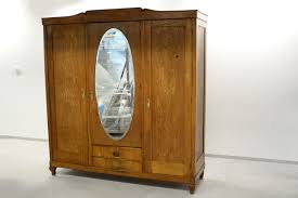 Crafted with a solid wood frame, it has shelving, drawers, mirrored doors and a softly distressed, multistep finish. The Armoire That Saved Her Life