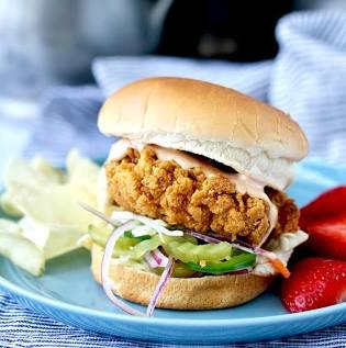 The Layered Approach: Pairing uniform crisp chicken with crisp cabbage and clean pickles., AI generated