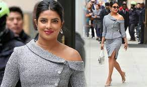 Priyanka donned a stylish look wearing a powder blue shirt with a plunging neckline and yellow. Priyanka Chopra Smoulders As She Flashes Pins In Sexy Split Skirt And Off The Shoulder Top Celebrity News Showbiz Tv Express Co Uk