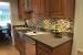 Natural Maple Cabinets With White Quartz Countertops