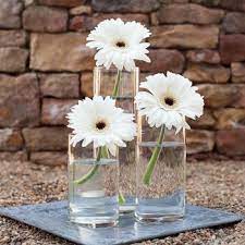 Glass Vase With Daisy And Candle Centerpieces Fiftyflowers Wedding Floral Centerpieces Flower Centerpieces Wedding Daisy Centerpieces