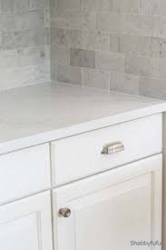 Your dream kitchen is more affordable than you think. Carrara Marmi Quartz Counter With White Cabinets