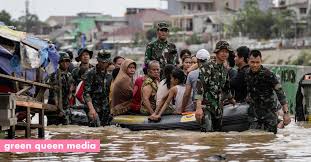 Britain weather a woman stands in the rain in horse guards parade in central london, sunday july 25, 2021. Climate Crisis 30 Dead Thousands Evacuated Due To Jakarta Flash Floods