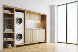 How do you build a counter over a washer and dryer? White Laundry Room Interior With Wooden Countertops A Closet Stock Photo Picture And Royalty Free Image Image 92872344