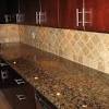 Dark countertop perfectly matched with metal looking backsplash and. 1