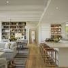 Ceiling beams discreetly separate the dining area, living room, and kitchen in this open concept floor plan. 3