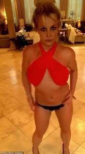 New britney spears merchandise available now! Britney Spears Sets Pulses Racing As She Does Provocative Dance In Sexy Red Halter Top On Instagram Daily Mail Online