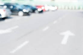 Driver using car sharing app on phone and searching vehicle. Blurred Background With Cars Parked On Parking Lot 209882006 Larastock
