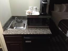 wet sink, microwave, coffee maker in