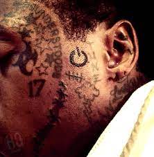 Some people have said that it means carter which is his last name. Lil Wayne Tattoos The Power Symbol On His Face