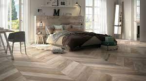 Some designs, especially higher end ones that mimic the look of reclaimed hardwood, also come in mixed widths for a more authentic overall appearance. Wood Look Tile 17 Distressed Rustic Modern Ideas Bedroom Flooring Floor Tile Design Wood Look Tile