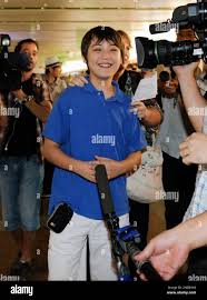 American boy Jonathan Lee smiles as he is surrounded by journalists after  returning from North Korea at the airport in Beijing Thursday, Aug. 19,  2010. Lee, 13, who returned Thursday after making