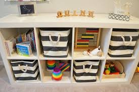 Adorable Play Room Storage Featuring Ikea Expedit Shelving Unit Filled With The Container Store Rugby Stripe Bins To Playroom Storage Playroom Playroom Design