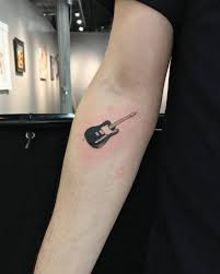 The conventional and custom design tattoo but the armpit region those are the society a bit of tattoo guitar designs whatever they have got to go and they're not all easy. Black Electric Guitar Tattoo On The Right Inner Forearm Tattoos For Guys Tattoos Guitar Tattoo Design