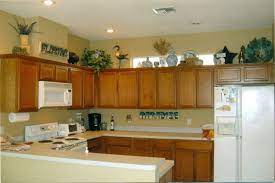If the space above the kitchen cabinets is open you essentially have a high shelf that can be used to display decorative items or even to store items that are infrequently used. The Tricks You Need To Know For Decorating Above Cabinets Laurel Home