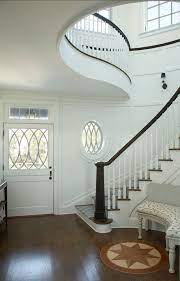 There S So Much To Love In This Curvaceous Foyer From Its Dutch Door To The Unique Coastal Inspired Newel Post Paint Color House Design Shingle Style Home