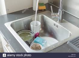 kitchen sink. pile of dirty dishes
