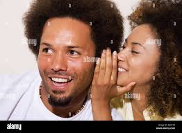 African couple telling secret Stock Photo