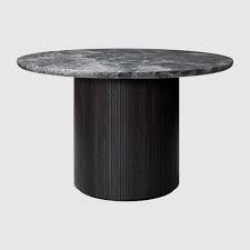 Round white marble top perched atop a dark metal base, a classic combination, curved tubular legs accent the circular shape in a graceful fashion. Moon Dining Table Round 120cm Diameter Marble Top Gubi Webshop