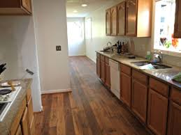 To avoid making the space feel cramped with furniture, mix and match different types of cabinets. Flooring With Honey Oak Kitchen Cabinets Ideas Large Vinyl Floor Tiles Floor Your Home Idea Honey Oak Cabinets Hardwood Floors In Kitchen Light Oak Cabinets