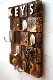 A colorful framed photo of a farm hangs cheerfully between them. Personalized Men Key Hook Key Rack For Wall Wooden Key Holder Wood Key Hanger Wall Key Hanger Wood Key Organi Diy Holz Schlusselhalter Diy Projekte Aus Altholz