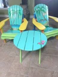 Hand Painted Andirondack Chairs With The Theme Of Beach Design Blue And Green Calm Color And Round Table Wi Hand Painted Chairs Painted Chairs Beach Furniture