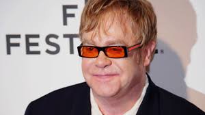 Elton John falls at charity match, bounces back