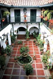 Two Story Courtyard With Spanish Tiles And Archways Spanish Style Home Interior Decor Spanish Style Homes Hacienda Style Homes Spanish House