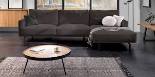 A gray couch is a classic choice for living room seating. 10 Decorating Ideas For Living Rooms With A Dark Grey Sofa Kave Home