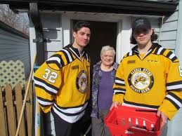 Hockey players assist Canadian Red Cross volunteers