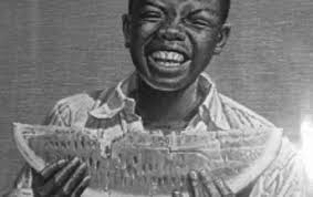 Un negru mînca o felie de pepene