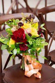 Maybe you would like to learn more about one of these? Deep Red Bright Yellow Pink And Green Wedding Bouquet Roses Peonies Peach Ribbon Standing On Dark Wooden Chair Kyo Morishima Photography