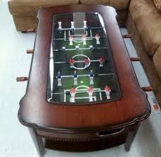 It features a clear glass top over a playing field, serving as a great resting spot for snacks and beverages. Classic Foosball Coffee Table