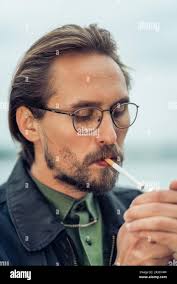 Man with beard smoking cigar hi-res stock photography and images