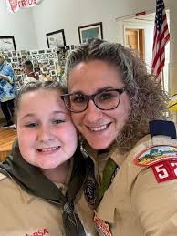 Family achieves scouting milestone with girl crossing bridge