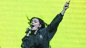 Guess: Charli XCX and Billie Eilish donate pants from new video
