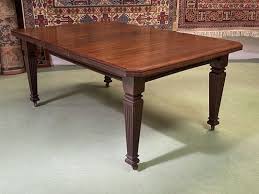 The table has a rectangular paneled top with delicate inlaid silver wire. English Mahogany Dining Table 1930s For Sale At Pamono