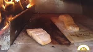 Salmon Cooking In A Wood Fired Pizza Oven The Base Of The Oven Himalayan Salt Slabs Delicious Video Brick Pizza Oven Wood Fired Pizza Oven Pizza Oven Outdoor
