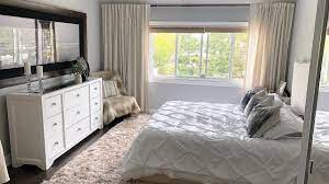 The hardwood floors give a rustic feel to an otherwise very modern bedroom design. White Beige Bedroom Decor Makeover Youtube