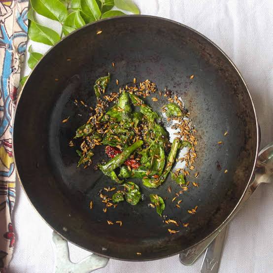 Tempering (*Tadka*) in hot ghee extracts and amplifies the fat-soluble essential oils of whole spices, AI generated