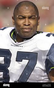 Seattle Seahawks running back Shaun Alexander (37) is tackled by Chicago  Bears defenders Alex Brown (96), Adewale Ogunleye (93) and Lance Briggs  (55) in their NFC divisional play-off game at Soldier Field