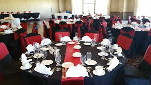 Black Table Cloths Deep Red Table Runners And Deep Red Satin Sashes Over Black Satin Chair Covers Is Dramatic And Red Table Large Wedding Venues Table Runners
