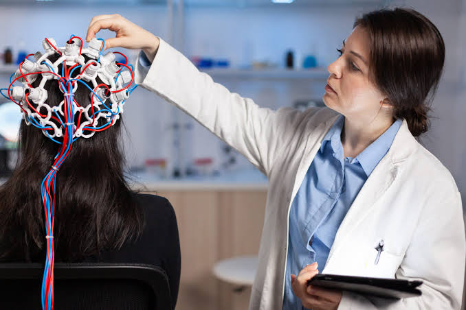 Neurologist reviewing diagnostic scans at Profrea